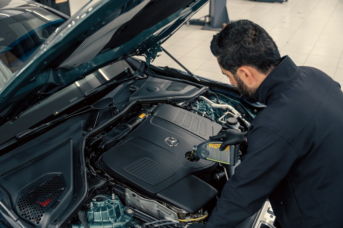 Mechanic inspecting a car engine before export